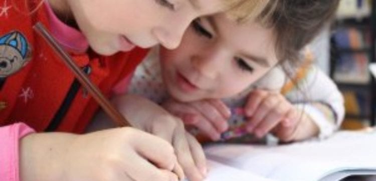 Young School Pupils Writing